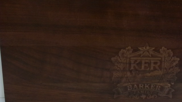 Close-up of custom laser engraving on a walnut cutting board