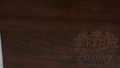 Close-up of custom laser engraving on a walnut cutting board